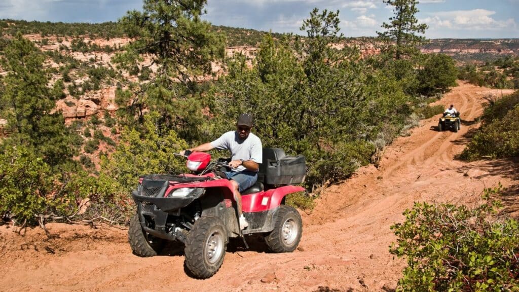 Man operating an ATV on an ATV Trail.